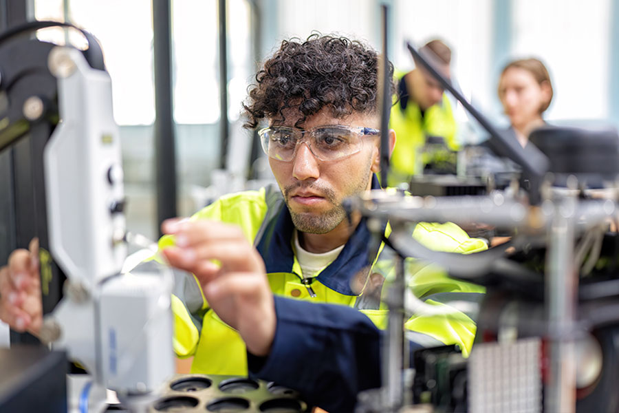 Maintenance engineer in hi-vis working on machinery