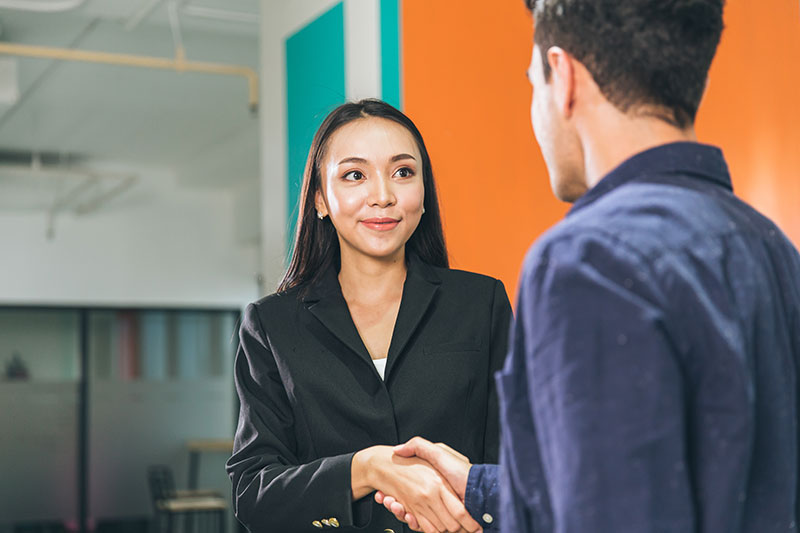 Professional candidate shaking hands at a job interview for an IT or engineering role in Norfolk